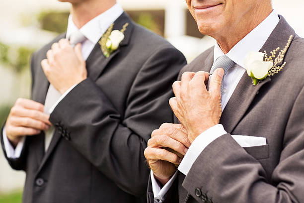 istock Man And Groom Adjusting Necktie In Garden 181048383