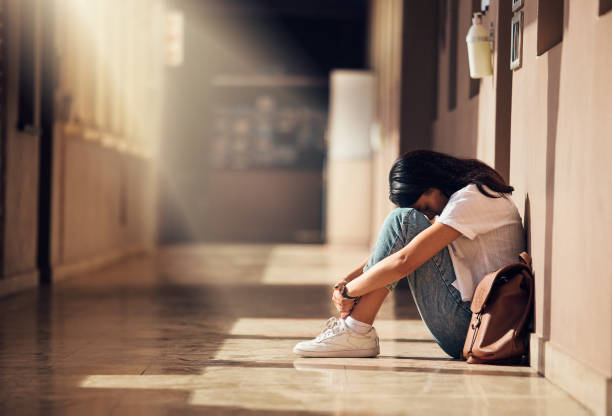 Stress, anxiety and depression of university girl with mental breakdown on campus floor. Frustrated, thinking and depressed indian woman suffering and overwhelmed with burnout at college. Stress, anxiety and depression of university girl with mental breakdown on campus floor. Frustrated, thinking and depressed indian woman suffering and overwhelmed with burnout at college. school alarm stock pictures, royalty-free photos & images