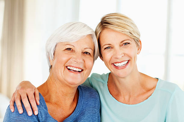 istock Woman With Arm Around Mother At Home 181048687