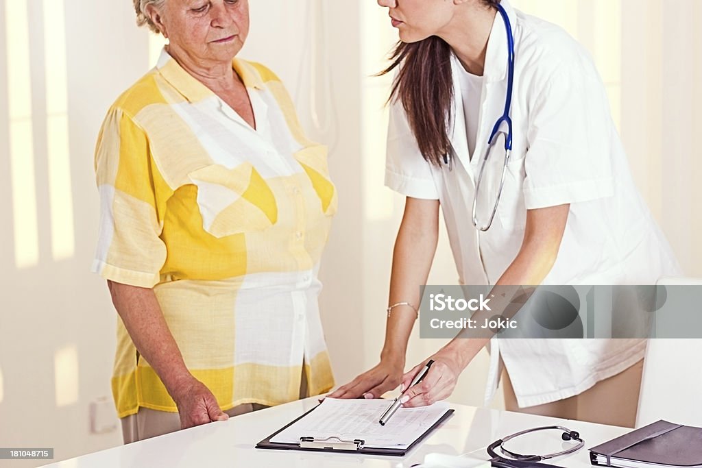 Young doctor with patient. Young doctor with patient in  office. 60-69 Years Stock Photo