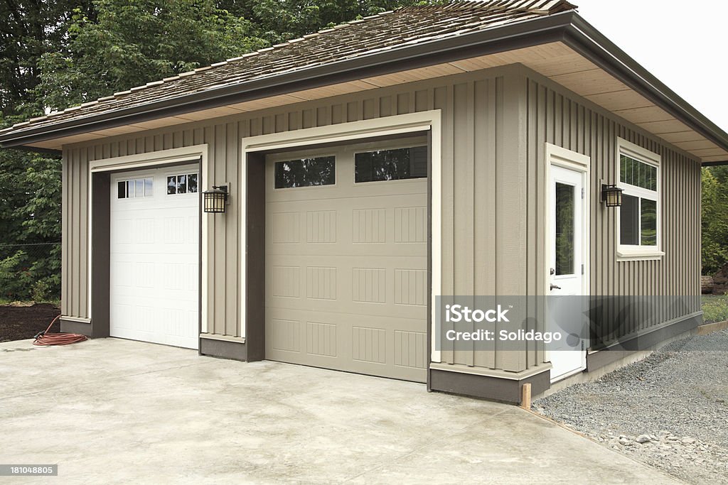 Modern New Two Door Detached Garage New modern free standing two door detached garage. Detached House Stock Photo