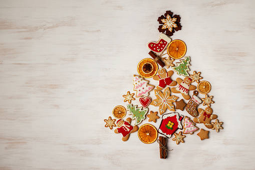 Christmas cookies laid out in the shape of a Christmas tree, overhead view. Christmas background with copy space. Flat lay. Part of the series.