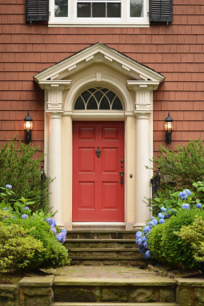 istock Red brick house with red front door 181049820