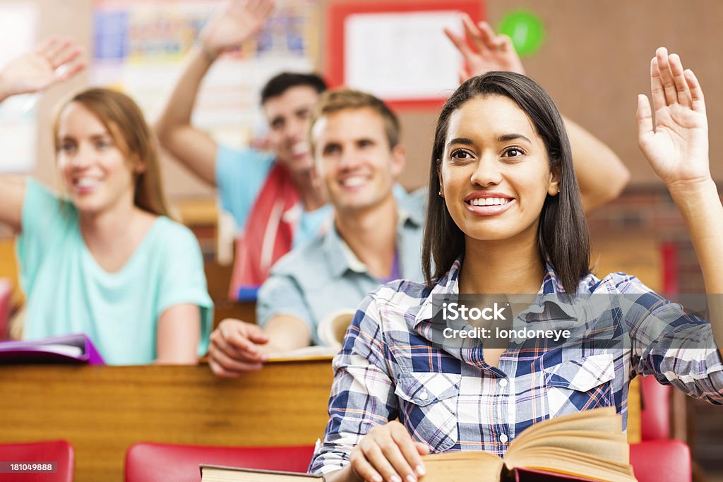 Alunos levantar as mãos para responder a pergunta em sala de aula - Foto de stock de 16-17 Anos royalty-free