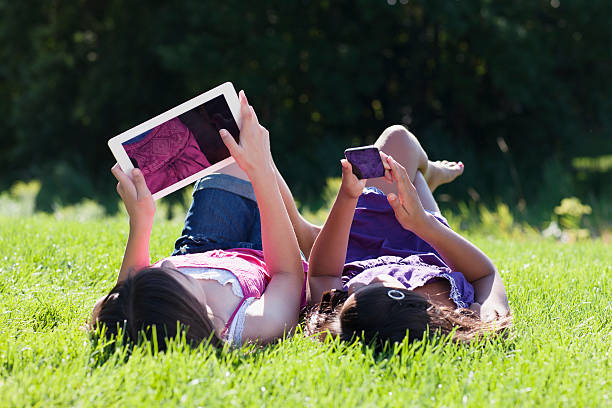 istock Girls Playing MP3 player and Digital Tablet 181049969