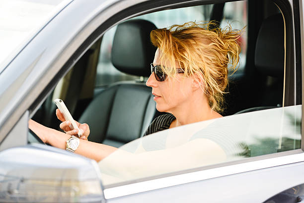 istock Mature Woman Driving Car and Texting 181051272