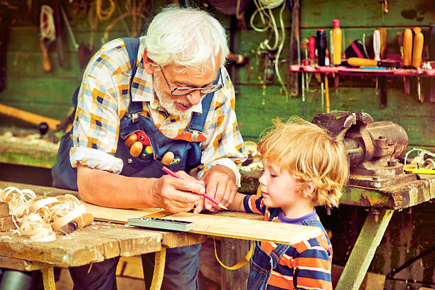 istock Grandfather and grandson in workshop 181052082