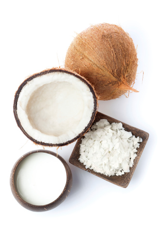 Subject: Various coconut agricultural products, whole fruit, shredded flakes, and coconut milk. Isolated on white background.