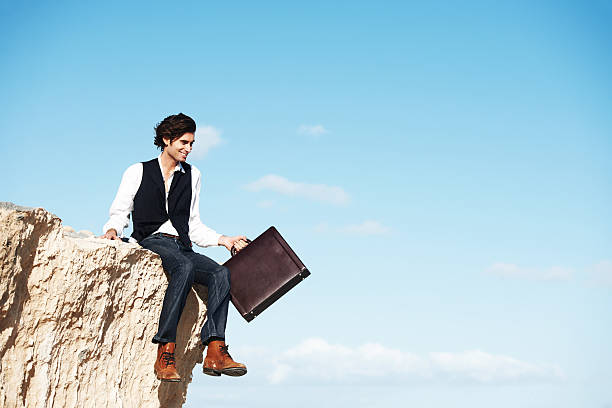 escapismo - on top of business cliff businessman fotografías e imágenes de stock