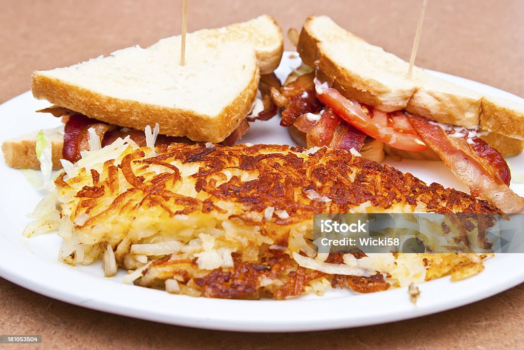 BLT-Sandwich BLT-Sandwich with Hash Browns.  The standard BLT is made up of five ingredients: bacon, lettuce, tomato, mayonnaise, and bread. The image shows an additional side order of hash browns. American Culture Stock Photo