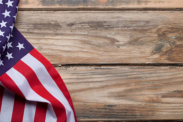 istock American flag on wooden background 181053728