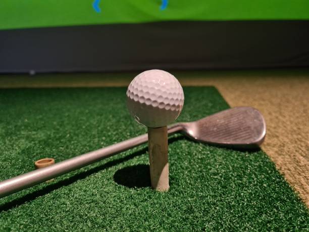istock White ball and golf club on golf carpet 1810537543