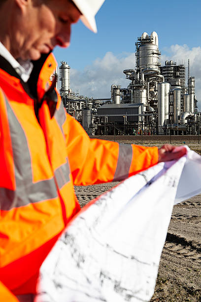 istock Petrochemical inspector with drawing 181054056