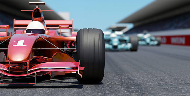 Leading the Race Close front view of a red race car on a track. High resolution 3D render. motor racing track stock pictures, royalty-free photos & images
