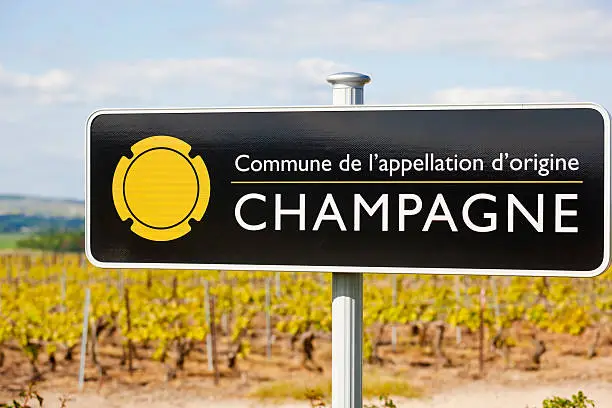 "A road sign marks the Champagne region in Northern France. An Appellation d'Origine ContrA'lAe, AOC, wine region."
