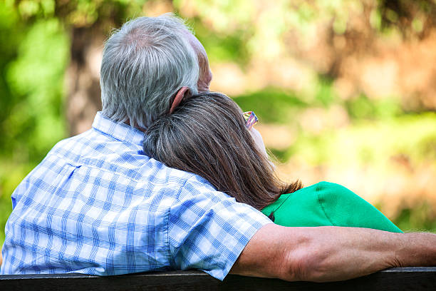 istock Senior couple sitting on bench in park, rear view 181054966