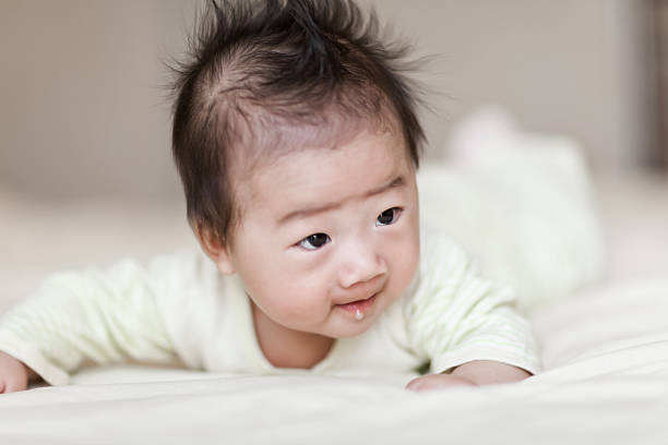 istock Sweet little baby boy crawling on white bed 181056894