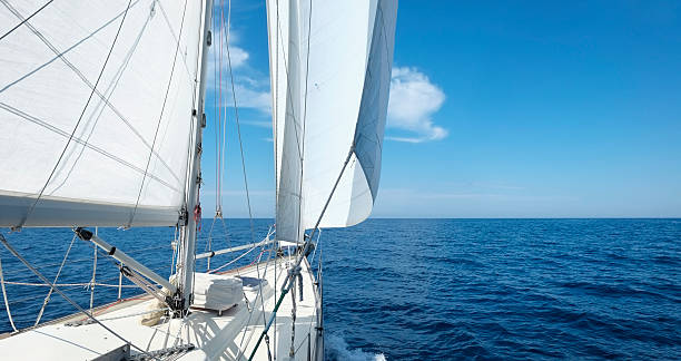 istock Yacht with white sails sailing towards the horizon 181056962