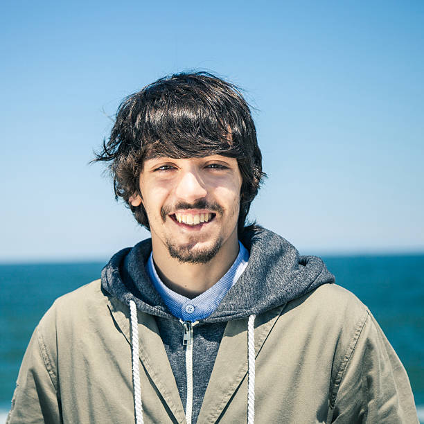 istock Smiling teenager looking at camera outdoors 181057049