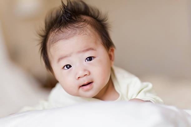 istock Sweet little baby boy crawling on white bed 181057495