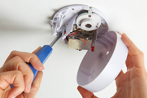 Installing Smoke Detector At Home Taking safety precautions at home smoke detector photos stock pictures, royalty-free photos & images