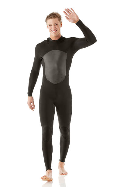 istock Happy man in wet suit waving his hand 181058095