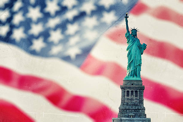 istock Statue of liberty against us flag 181058213