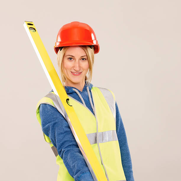 istock Young female worker with spirit level 181058380