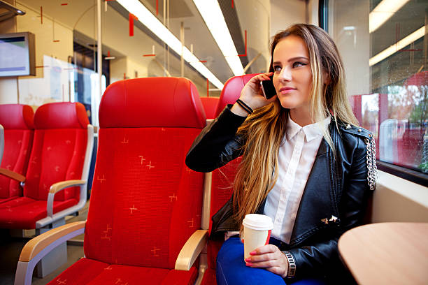 istock woman talking on phone in  train 181058431