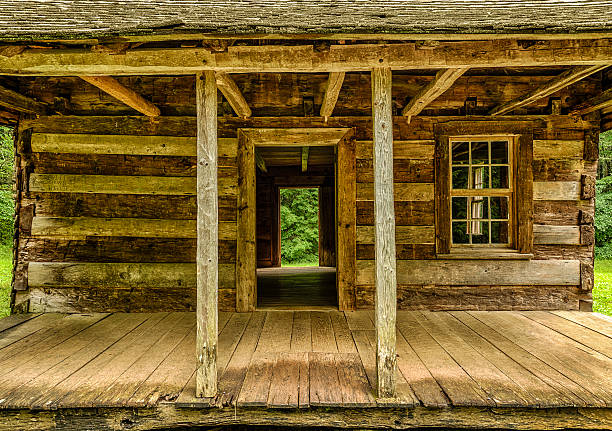 Pioneer Cabin Architecture A close-up look at a century-old pioneer cabin in the Cades Cove section of the Great Smoky Mountains National Park.  HDR image. wooden porch stock pictures, royalty-free photos & images