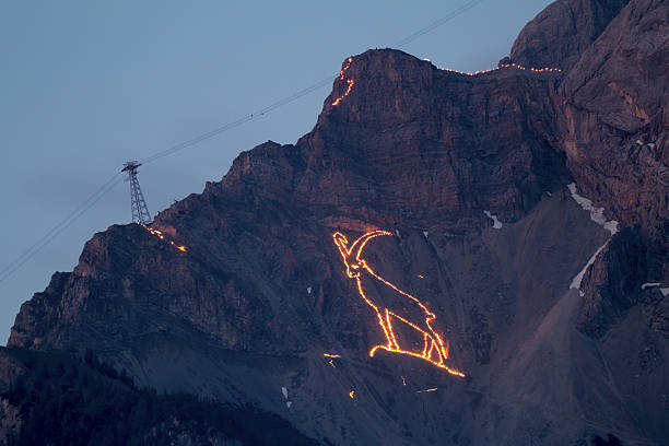 midsummer festival / nightshot - solstend fire the centuries old tradition solstice in Tyrol  will celebrated with magnificent mountain fire.  zugspitze stock pictures, royalty-free photos & images