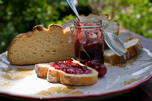 Home made cherry Jelly and bread, macro, shallow focus. Shot outdoors.