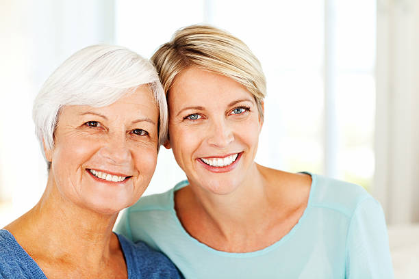 istock Mother And Daughter Smiling Together At Home 181059802