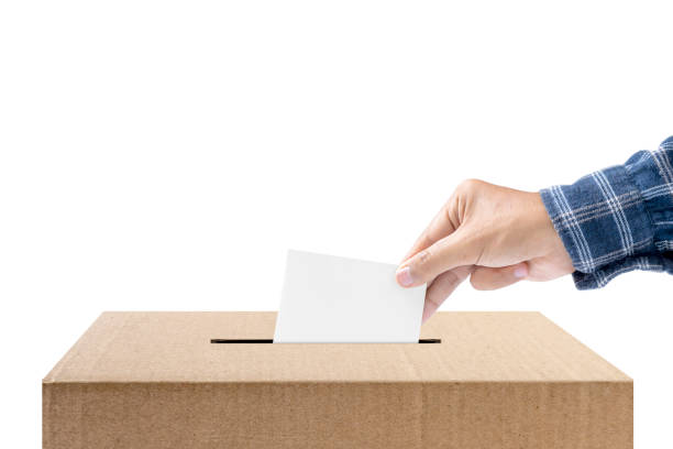istock Human hand inserts vote paper into ballot box 1810611975