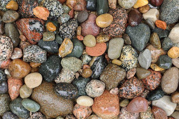 istock Wet River Rock Close Up, Smooth Rounded Granite Stones 181061469