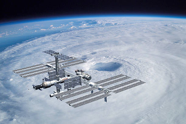 ISS space station over hurricane "International Space Station ISS above eye of hurricane Isabel. Composite photograph and 3D render, Adobe RGB. The earth image provided by NASA (http://eol.jsc.nasa.gov - image ISS007-E-14887)." international space station stock pictures, royalty-free photos & images