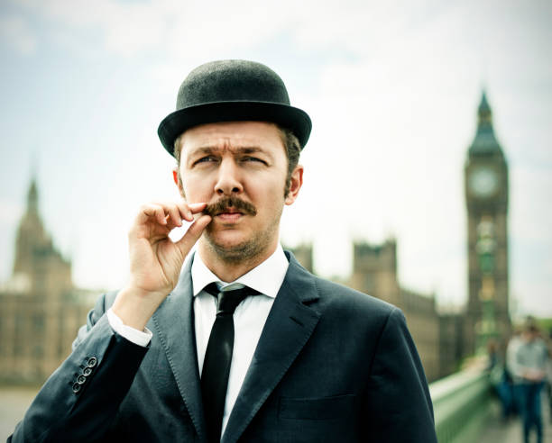 Englishman Englishman in London, with Bigben behind him bowler hat stock pictures, royalty-free photos & images