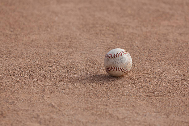 istock Softball sitting on the infield dirt 181062545