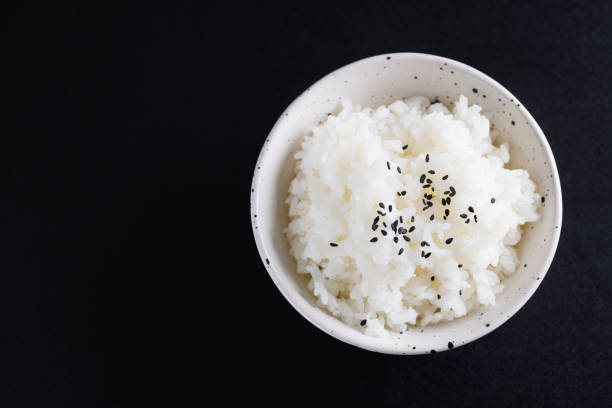 istock Japanese rice on cup isolated in black background 1810626526