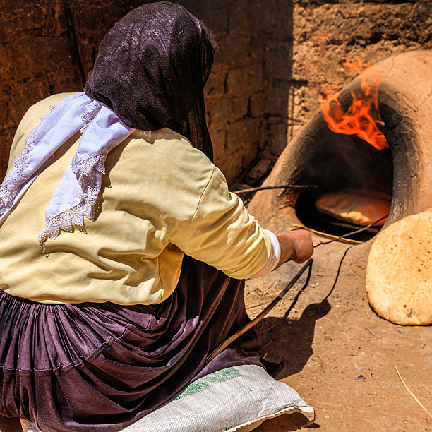 istock Moroccan woman making bread - khubz 181062927
