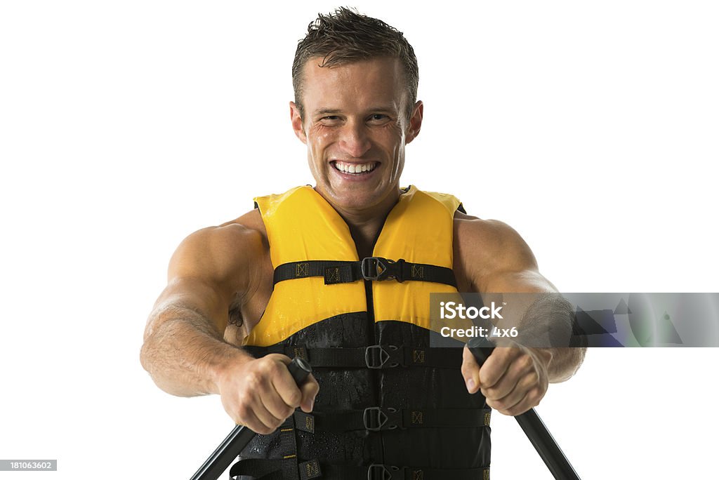 Portrait of a happy young man canoeing Portrait of a happy young man canoeinghttp://www.twodozendesign.info/i/1.png 20-29 Years Stock Photo