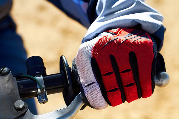 Protection for the hands is essential in motocross Closeup of a dirt biker's hand wearing a glove bmx racing stock pictures, royalty-free photos & images