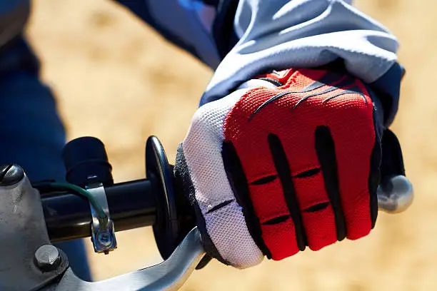 Closeup of a dirt biker's hand wearing a glove