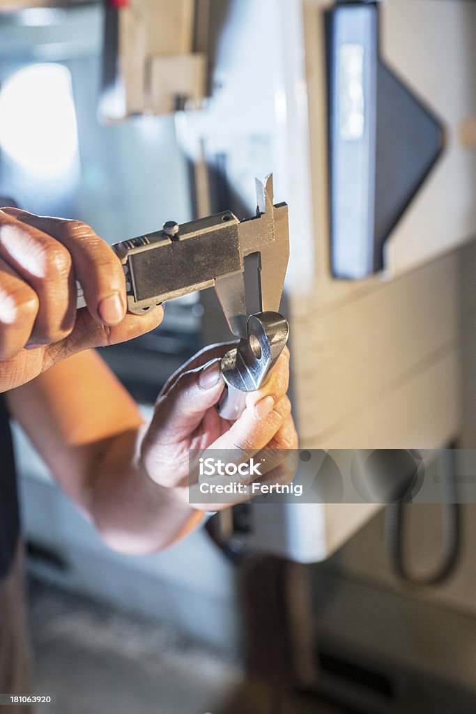 Quality control in a metal fabrication plant. A close-up of a part being measured for quality control in a metal fabrication plant. Aerospace Industry Stock Photo