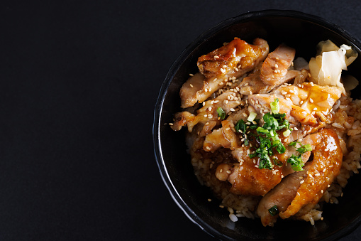 Grilled Chicken teriyaki rice Japanese food isolated in black background