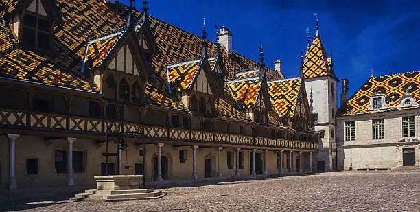 The hospice at beaune in the cote d'or department of Burgundy, France, Multi-coloured roof tiles.