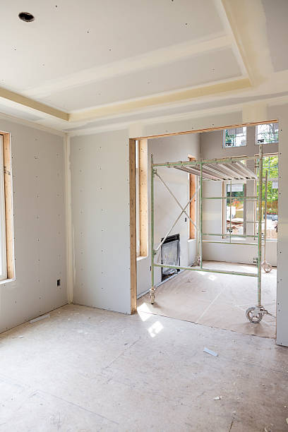 istock Drywall installation in a new home contruction 181064528