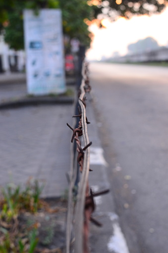 barbed wire used as a makeshift fence to prevent people from passing through