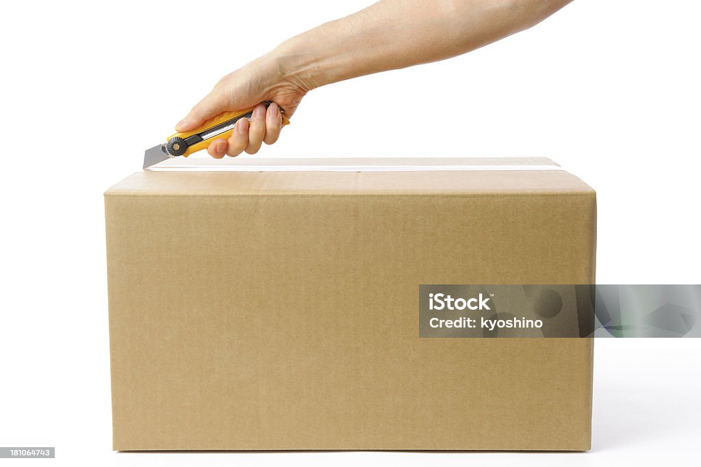 Using A Box Cutter To Open A Cardboard Box Stock Photo - Download