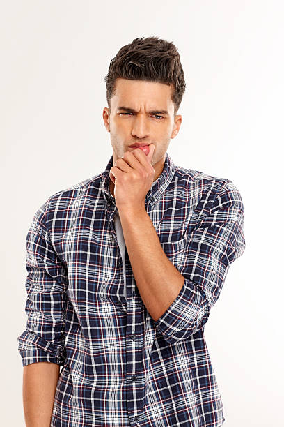 istock Confused young man standing on white 181064915